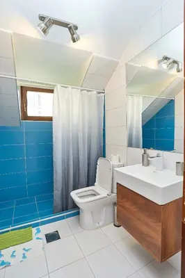 a bathroom with a toilet and a sink and a mirror at ŽUPAN apartmani in Soko Banja
