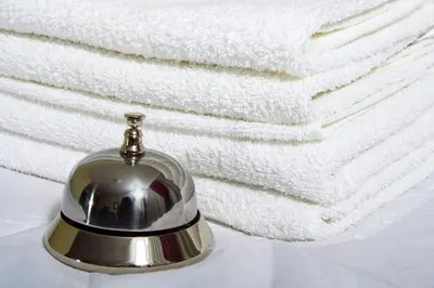 a silver bell sitting on top of a stack of towels at Vila Prica in Niška Banja