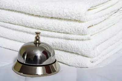 a silver bell sitting on top of white towels at Vila Prica in Niška Banja