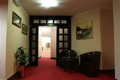 a hallway with a room with a red carpet and a door at Vila Prica in Niška Banja