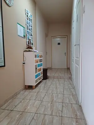 an empty room with a refrigerator and a hallway at Sobe SANjA in Pirot