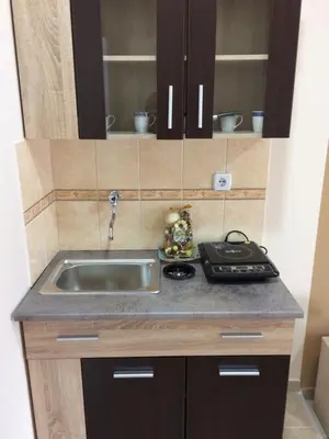 a small kitchen with a sink and a stove at Sobe SANjA in Pirot