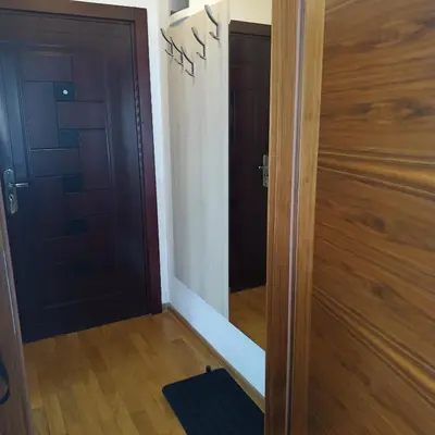 a door leading into a hallway with a mirror at Apartments Karamarković in Vrnjačka Banja
