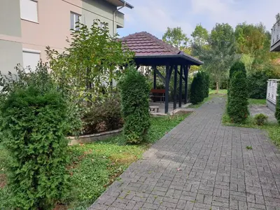 a garden with a gazebo in a yard at Studio Dunja in Vrnjačka Banja