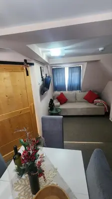 a living room with a couch and a table at Boni M in Kopaonik