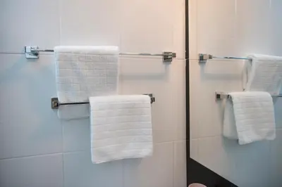 a bathroom with white towels hanging on a shower at Boni M in Kopaonik
