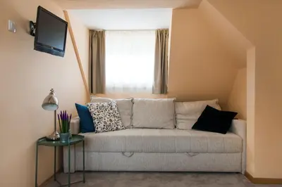 a living room with a couch and a window at Boni M in Kopaonik
