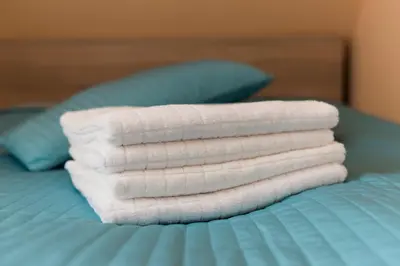 a stack of towels sitting on top of a bed at Boni M in Kopaonik