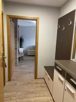 a hallway leading to a living room with a mirror at Leo in Niš