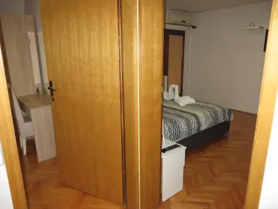 a door leading to a bedroom with a bed at Leo in Niš