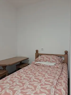 a bed and a table in a room with a bed at STD 