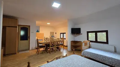 a room with a bed and a dining room at STD 