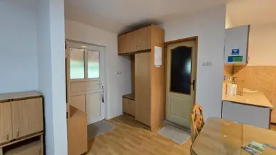 a small kitchen with a table and a small kitchen with a door at STD 