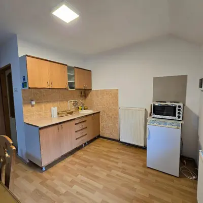 an empty kitchen with a refrigerator and a microwave at STD 