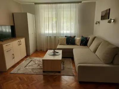 a living room with a couch and a coffee table at Apartment Holiday in Vrnjačka Banja