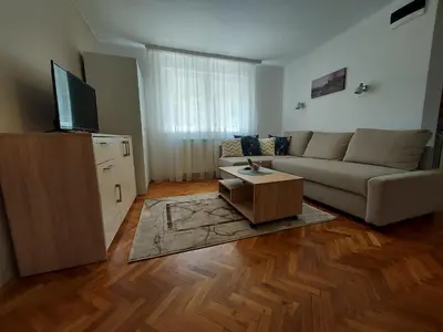 a living room with a couch and a tv at Apartment Holiday in Vrnjačka Banja