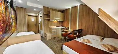 a small room with two beds and a table at Angella KOP Konaci in Kopaonik