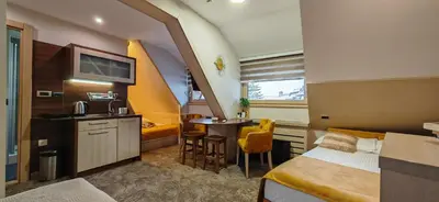 a hotel room with a bed and a small table at Angella KOP Konaci in Kopaonik