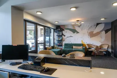 an office with a desk with a computer and a couch at NAR Royalton Accommodation in Niš