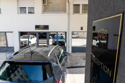 a car parked in front of a building at NAR Royalton Accommodation in Niš
