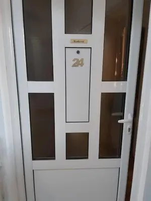 a sliding glass door with a sign on it at Stankovic Apartman in Vranje