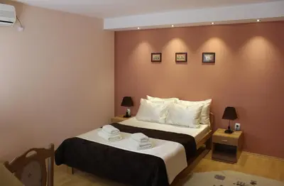 a hotel room with two beds and two lamps at Guest Accommodation Zone in Niška Banja