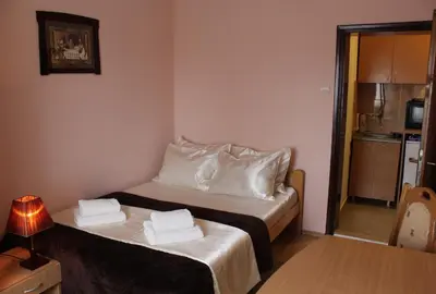 a small room with a bed with towels on it at Guest Accommodation Zone in Niška Banja