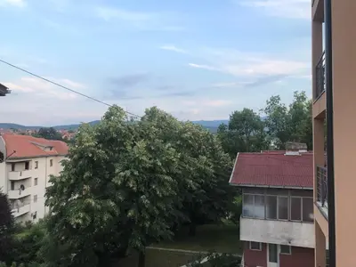 a view of a tree and a building at Apartman Sofia in Vrnjačka Banja