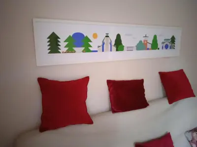 a white shelf above a couch with red pillows at Apartman NADA in Vrnjačka Banja