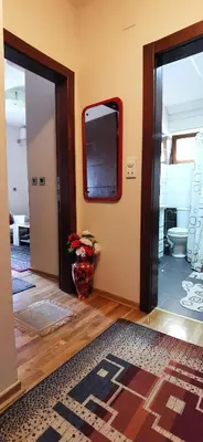 an open door to a room with a television on the wall at Apartman NADA in Vrnjačka Banja