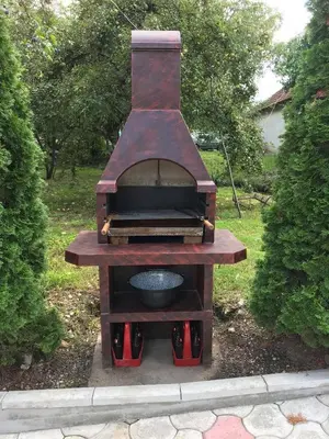 a wood fired grill sitting in a yard at Studio Ivana 1 in Soko Banja