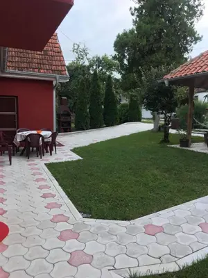 a patio with a table and chairs in a yard at Studio Ivana 1 in Soko Banja