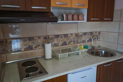 a kitchen counter top with a sink and a sink at Apartmani 
