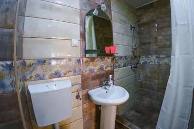 a bathroom with a sink and a toilet and a mirror at Apartmani 