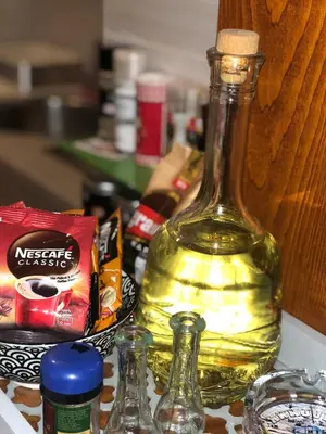 a bottle of wine sitting on top of a counter at Sunčani Apartman in Brzeće