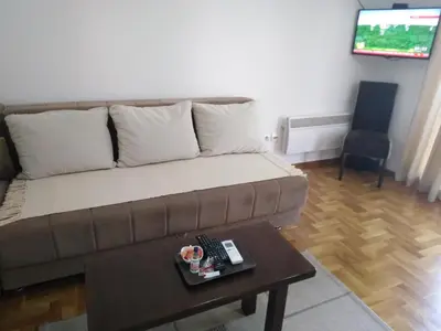a living room with a couch and a table at Apartment Laća in Vrnjačka Banja