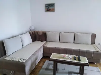 a living room with a couch and a coffee table at Apartment Laća in Vrnjačka Banja