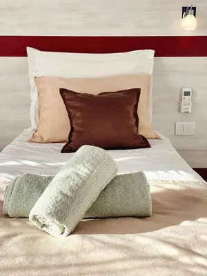 a large white bed with pillows on top of it at Apartmani Banja SPA in Vrnjačka Banja