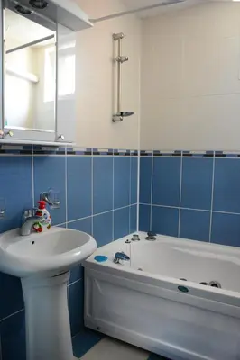 a blue and white bathroom with a tub and a sink at Apartmani Banja SPA in Vrnjačka Banja