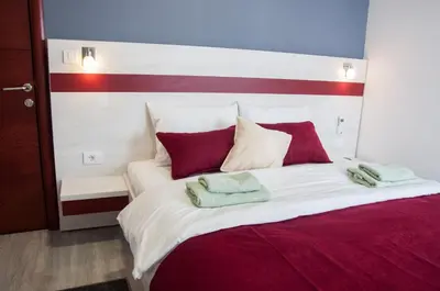 a large bed with two towels on top of it at Apartmani Banja SPA in Vrnjačka Banja