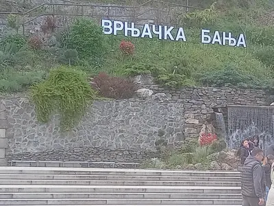 a group of people standing in front of a stone wall at Nidza Vranjanac in Vrnjačka Banja