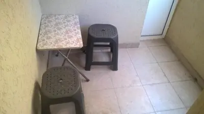 a table and two stools in a small room at Nidza Vranjanac in Vrnjačka Banja