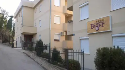 a building with a sign on the side of it at Nidza Vranjanac in Vrnjačka Banja