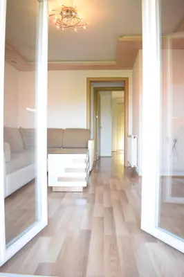 a room with a bed and a large mirror at Apartments Holiday in Vranje