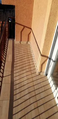 a staircase with a shadow on the side of a building at Apartments Holiday in Vranje