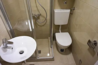 a bathroom with a toilet and a sink and a shower at Vila Plan 404 in Kopaonik