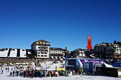 a group of people standing in the snow in front of buildings at Vila Plan 404 in Kopaonik