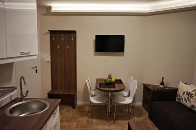 a small kitchen with a table and a living room at Vila Plan 404 in Kopaonik