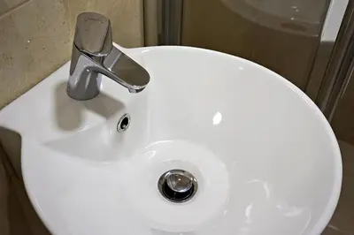 a white sink with a faucet in a bathroom at Vila Plan 404 in Kopaonik