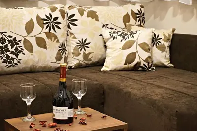 a bottle of wine and two glasses on a table at Vila Plan 404 in Kopaonik